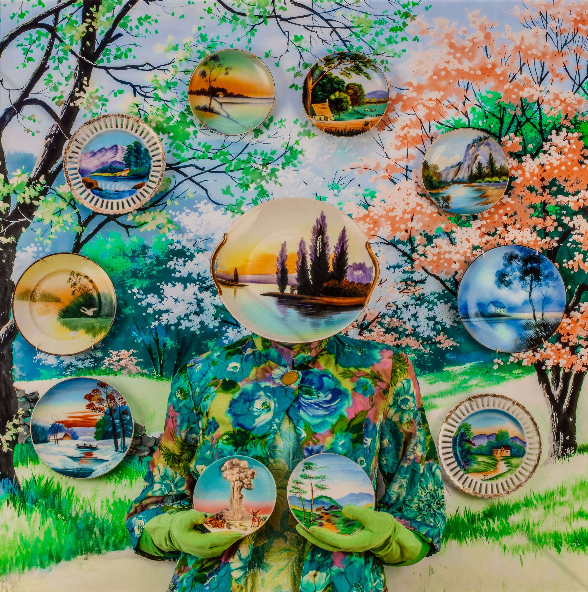 Colorful photograph of a female figure nearly camouflaged against the background holding up two decorative porcelain plates while another covers her face and other float agains the background around the figure.